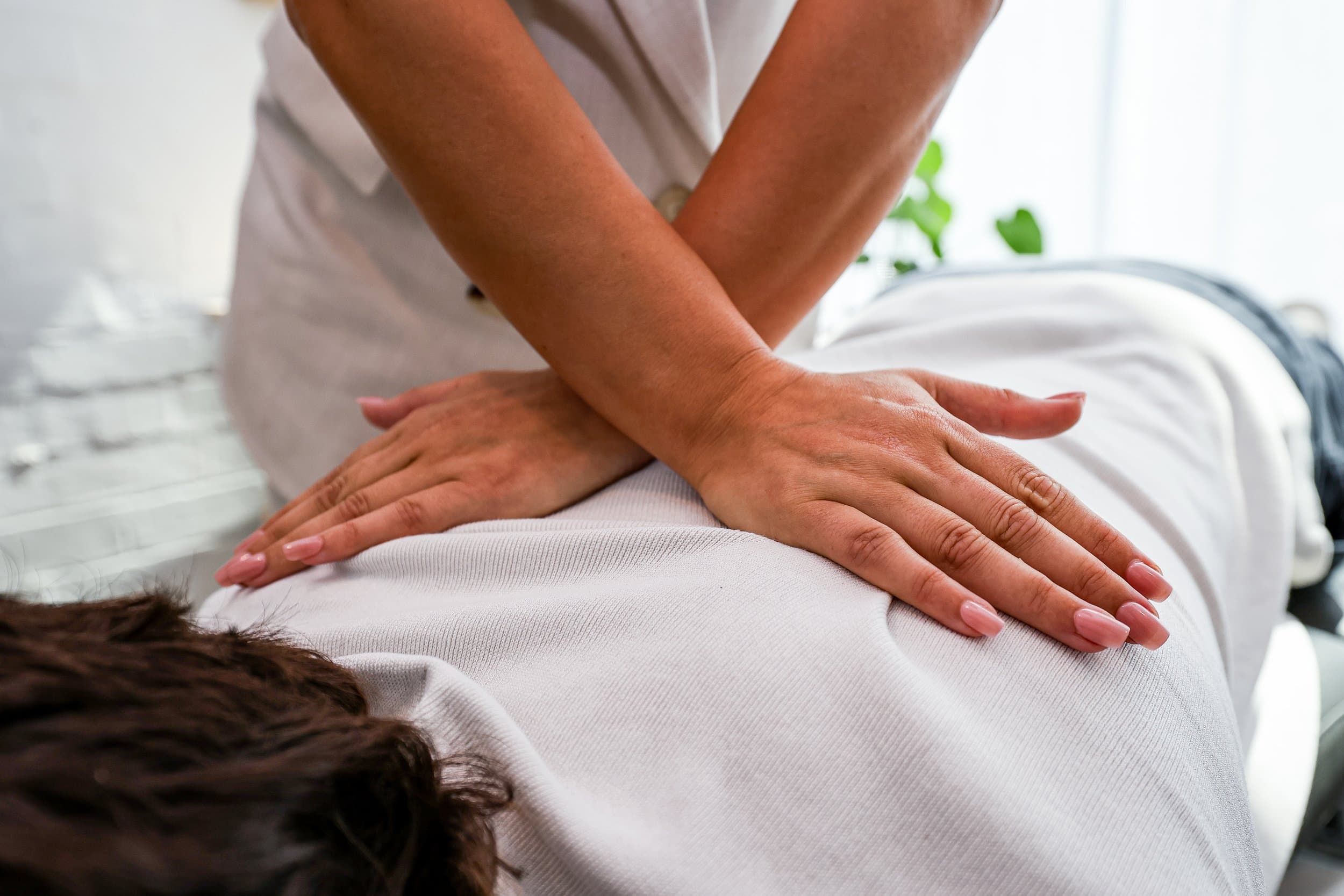 Hands-on chiropractic treatment on a patient's back