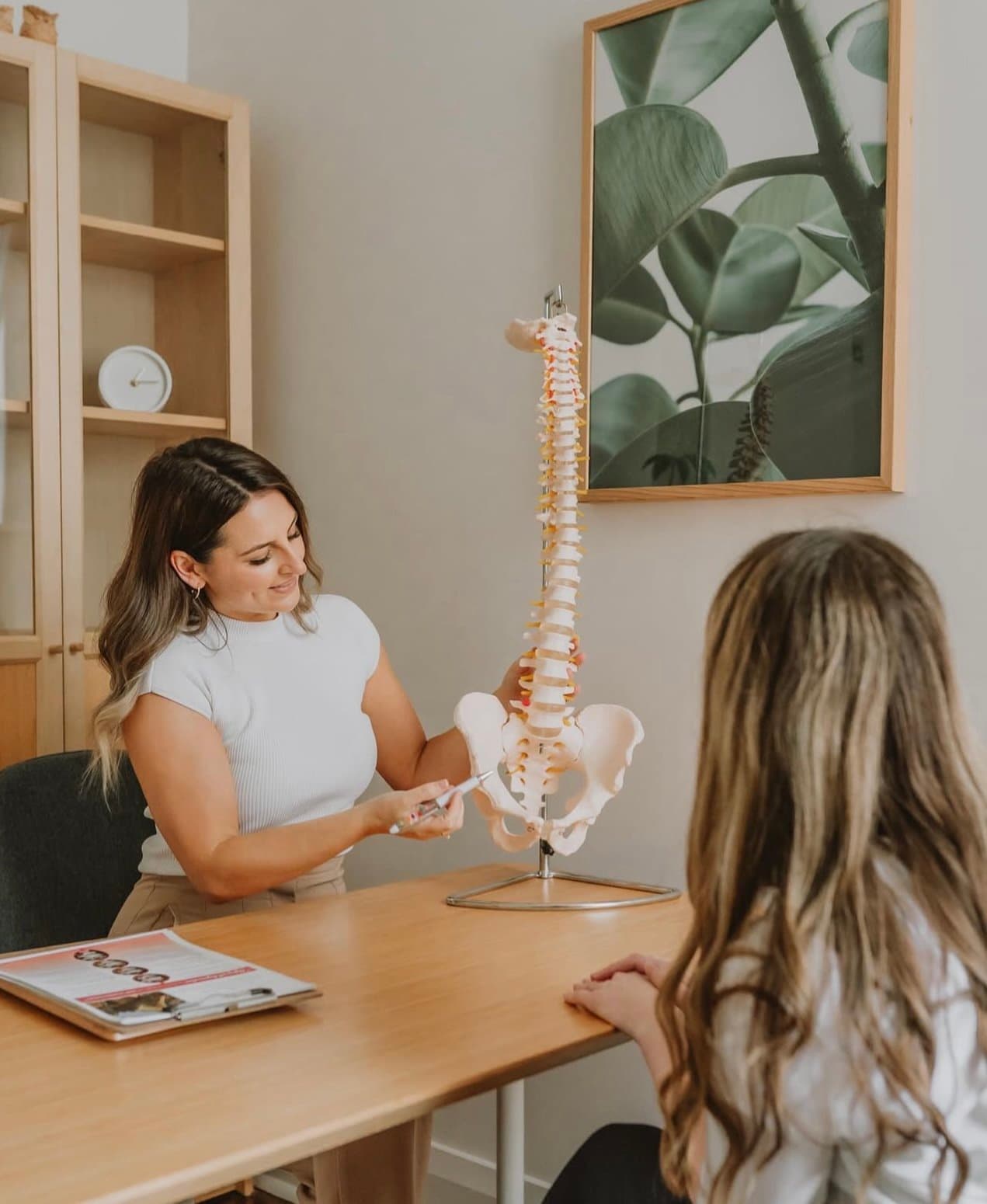 A chiropractor conducting a new patient consultation.